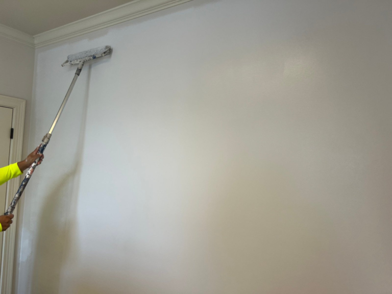 Painter rolling the finish coat on a commercial office wall in Middle Tennessee