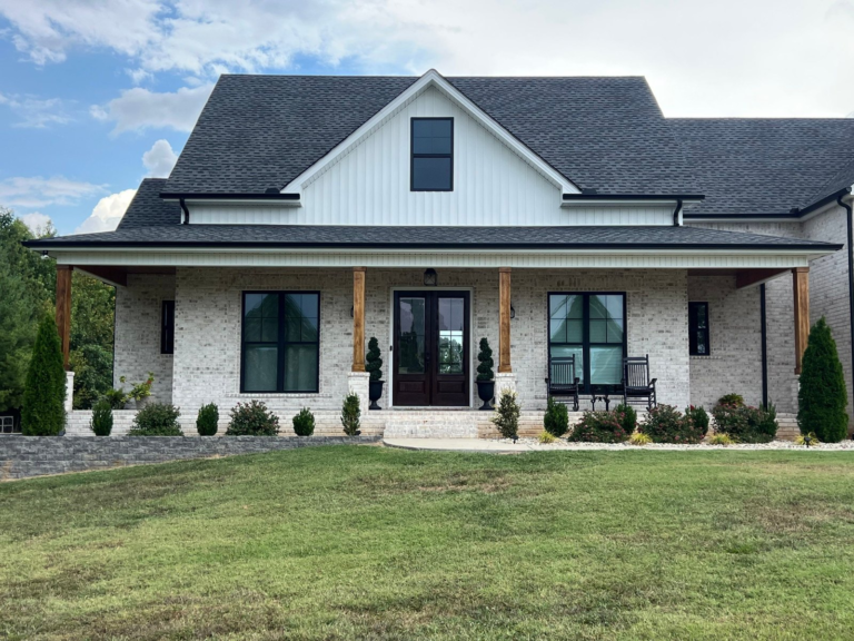 Farmhouse front porch with stained cedar columns and refinished double entry doors
