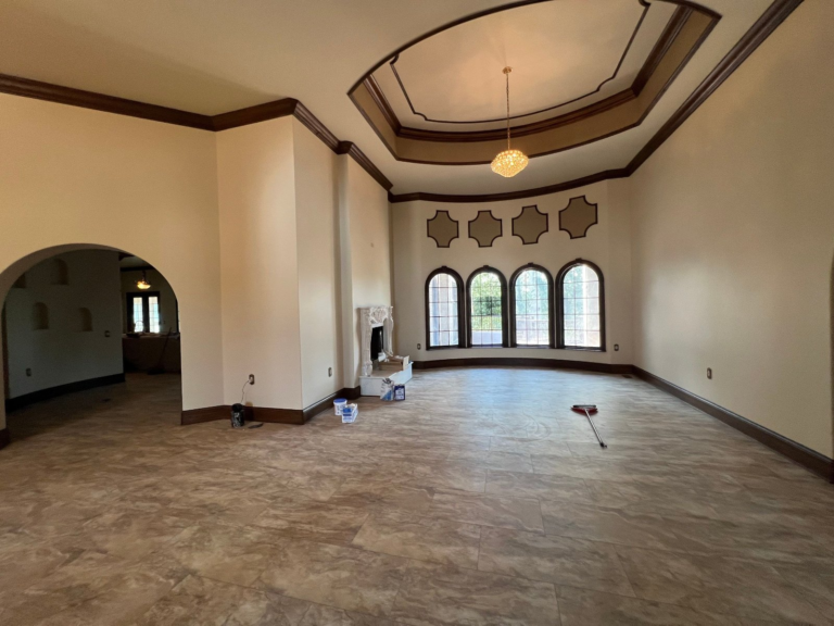 Great room with fresh walls, dark trim and a painted tray ceiling