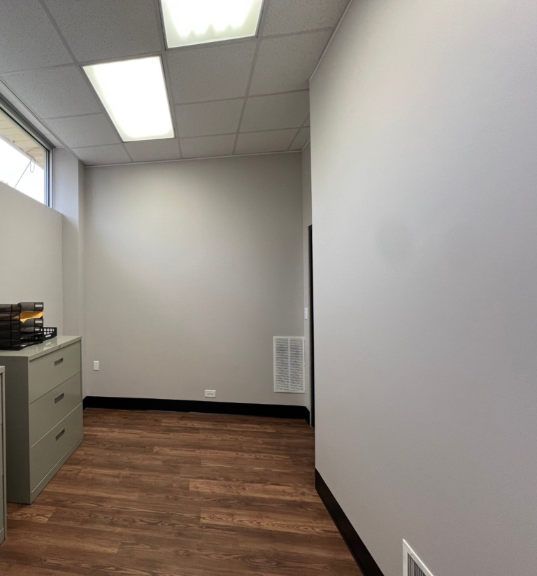 Repainted commercial office workroom with clerestory windows