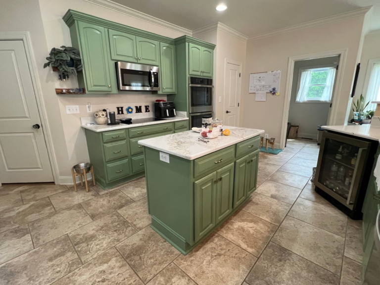 Sage green painted island and perimeter cabinets